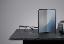 Tech Products . A high-tech studio table displaying prototype smart glasses, a foldable mobile display, and a sleek next-generation smartwatch under professional studio lighting..png