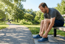 daily habits -A person tying their running shoes on a sunny morning, preparing for a daily outdoor walk to support long-term physical health.